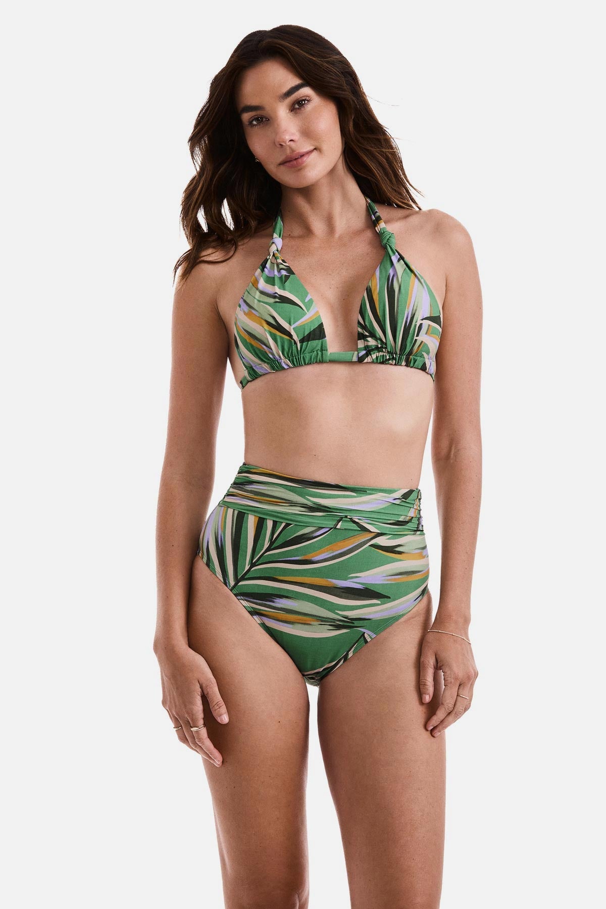 Woman wearing a multicolored leaf printed bikini top and matching swim bottoms